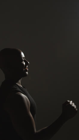 Vertical-Video-Close-Up-Side-View-Studio-Shot-Of-Male-Basketball-Player-Shooting-Ball-At-Basket